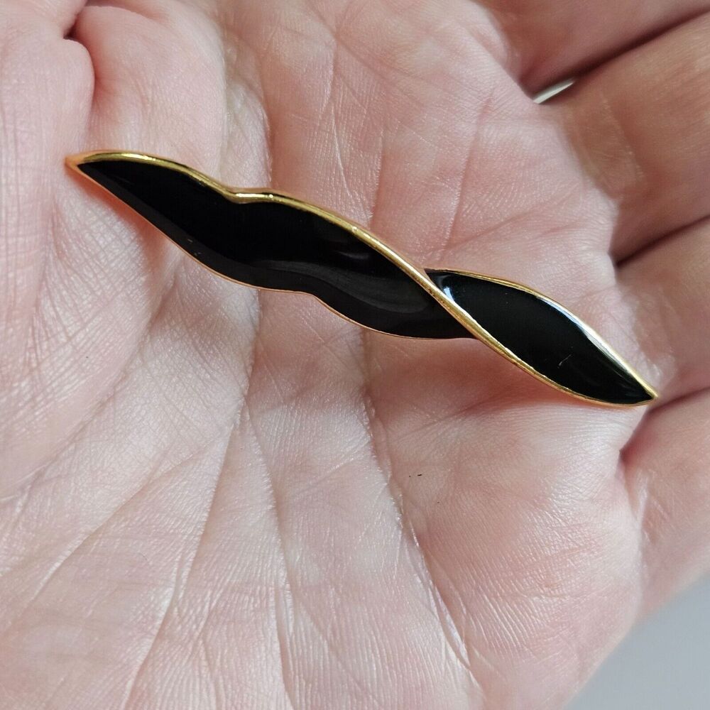 Gold plated black enamel swirl like brooch